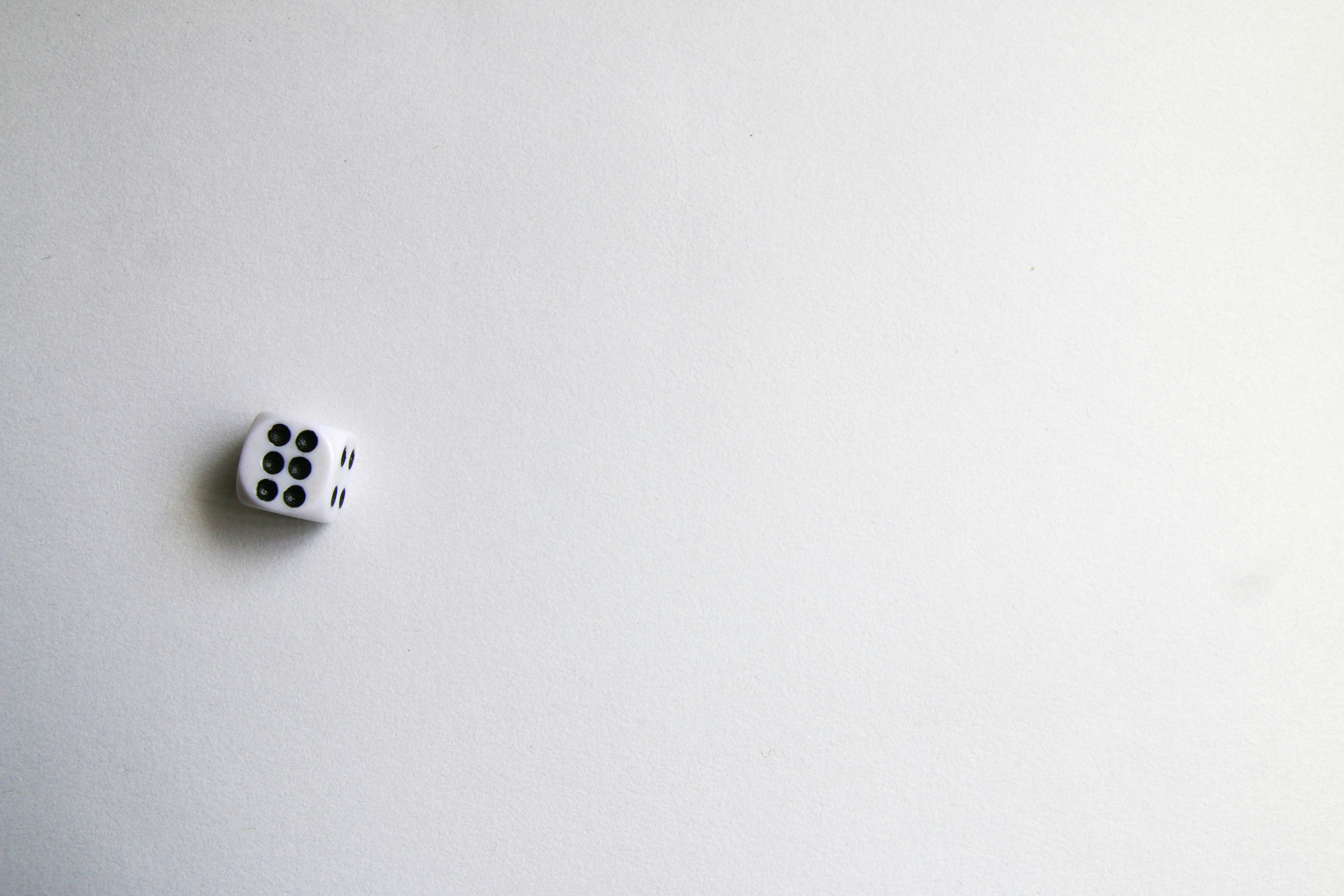 white and black dice on white surface